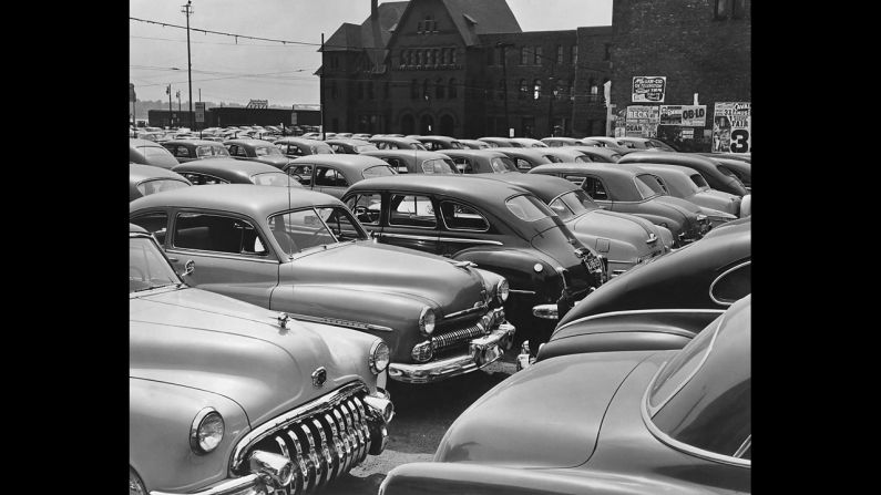 The American automobile industry has been centered in Detroit. Rows of these behemoths in a city parking lot around 1960 show the industry at its height.