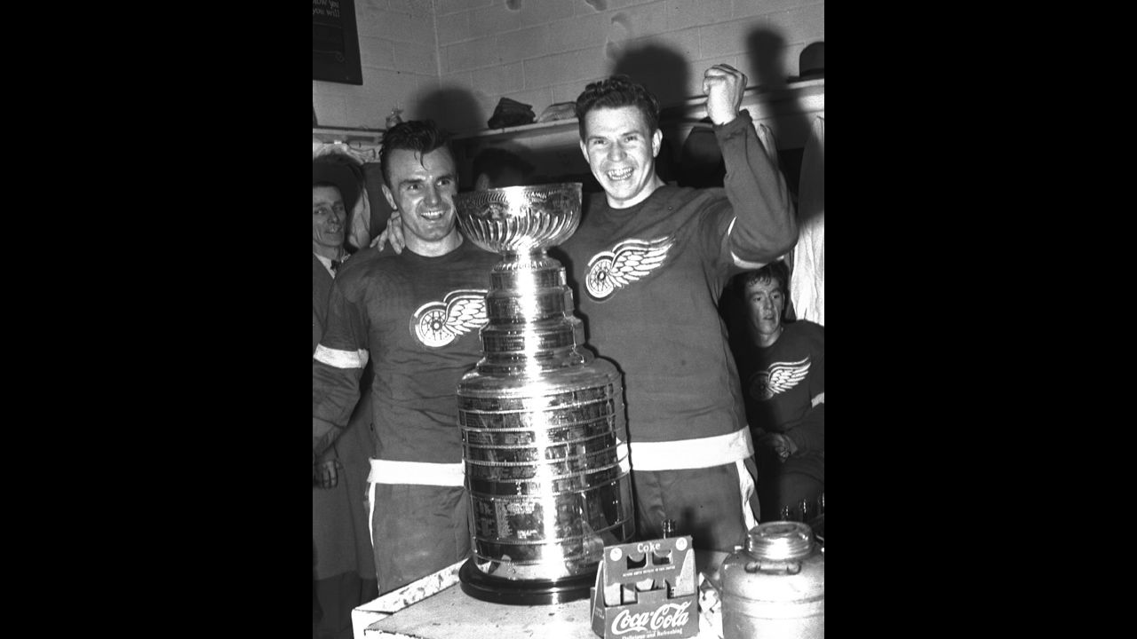 Pete Babando, left, and Harry Lumley of the Detroit Red Wings celebrate in the locker room with the Stanley Cup after defeating the New York Rangers in the 1950 Stanley Cup finals in Detroit.
