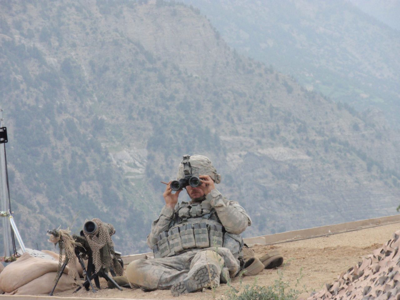 Carter on top of an Afghanistan Support Group (ASG) hut, providing eyes on an enemy attack and the approach/extraction route.