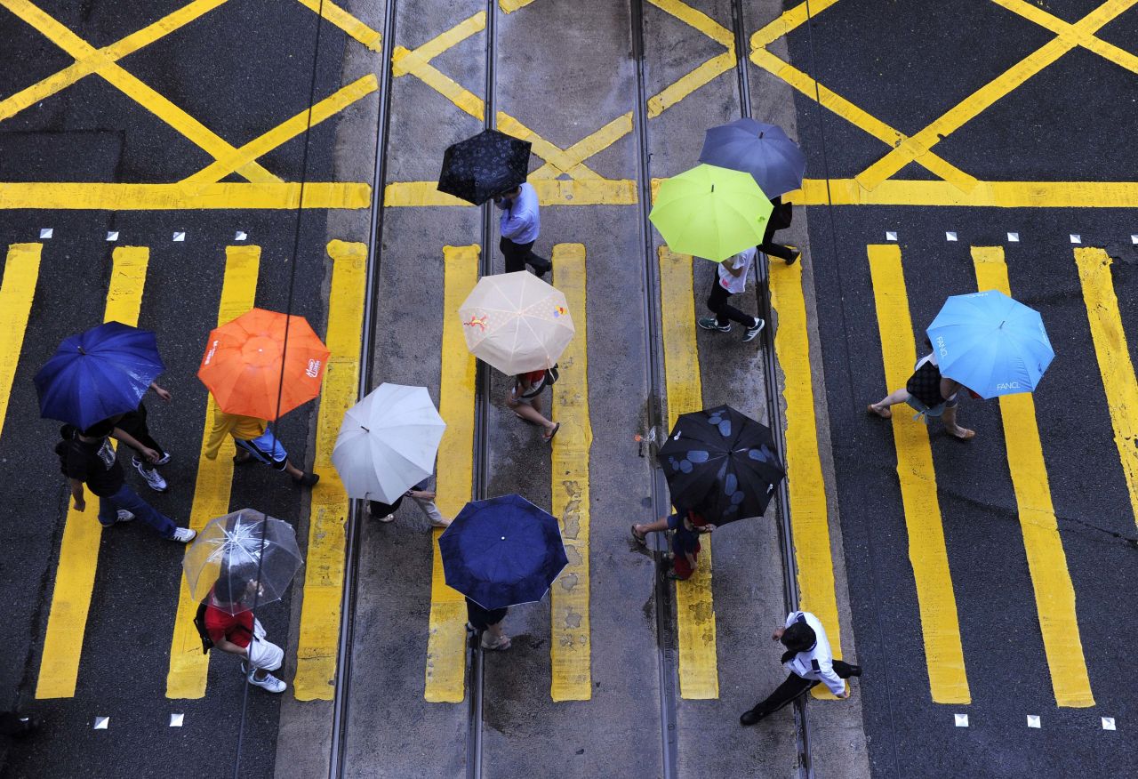 Umbrellas are out in force at an intersection in Hong Kong on Thursday, July 25.