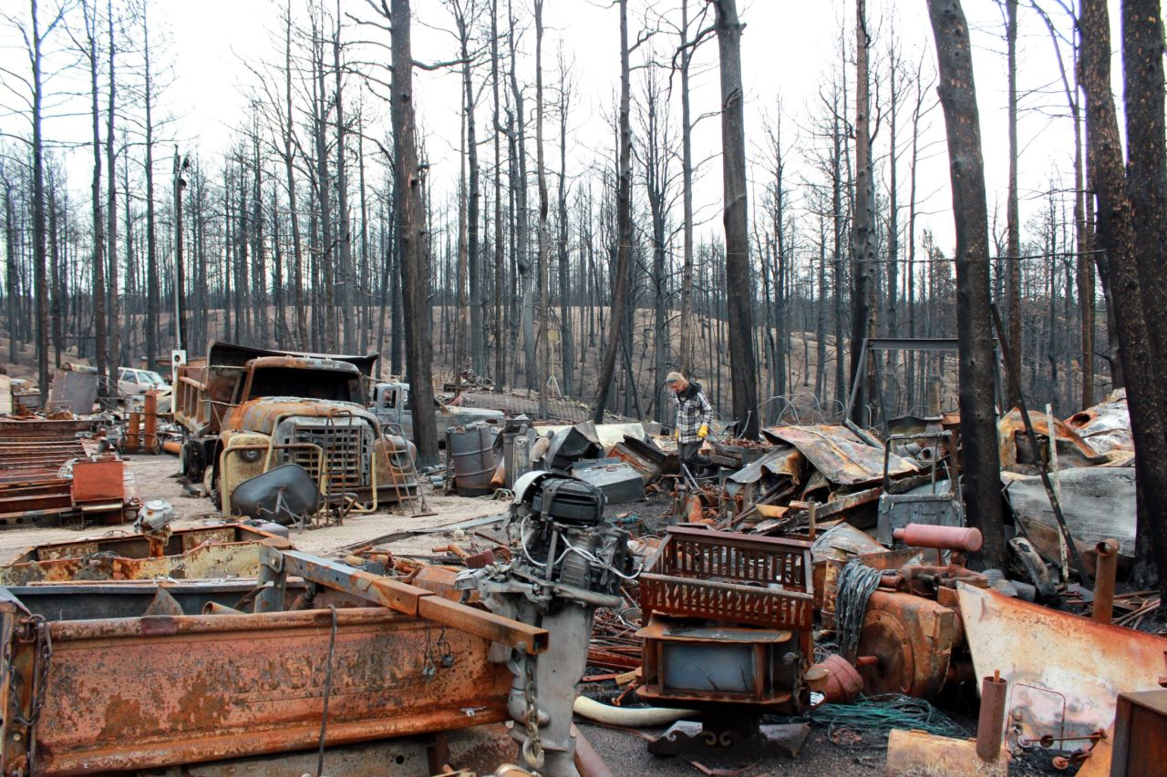Alan Havens inspects his burned and rusty belongings on July 15. His mobile home and work equipment were lost in the fire.