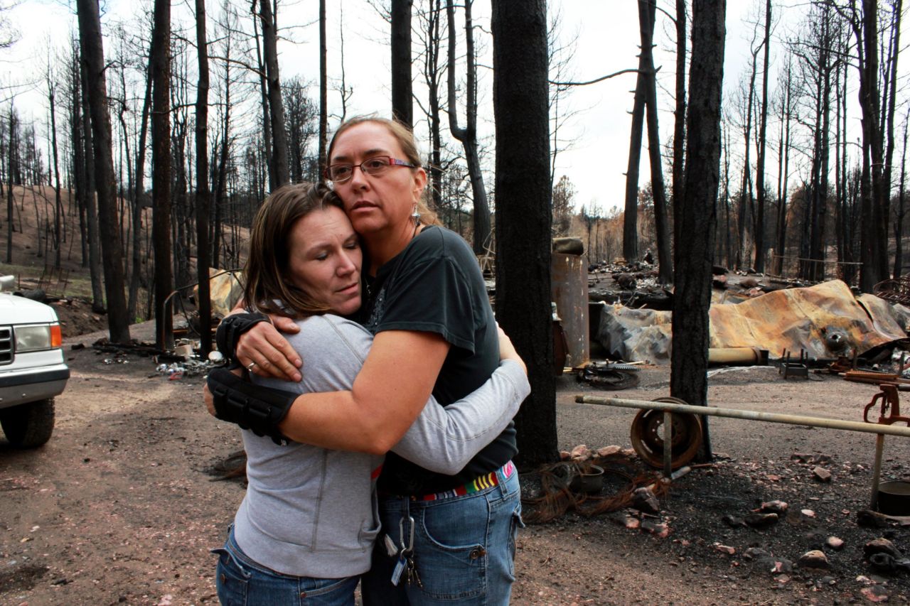 Amanda Davis, left, comforts Michelle Andree on Monday, July 15, after Andree came to see what damage heavy rains had done to her cleanup effort. Davis, whose home survived the fire, founded the nonprofit Crosses for Losses for victims of the June fire that burned through the Black Forest community.