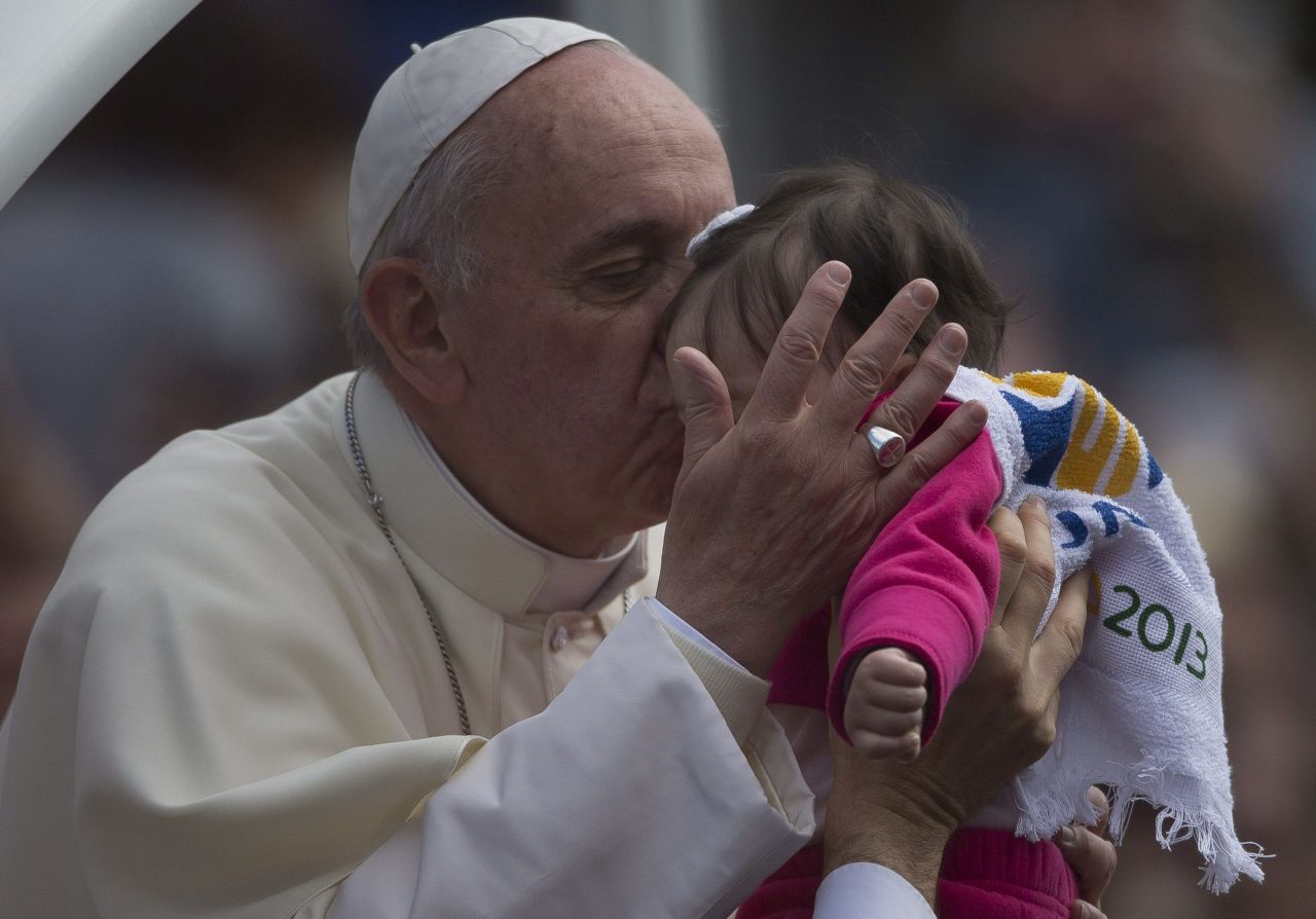 Pope Francis kisses a child in San Joaquin Square in Rio de Janeiro on July 26.