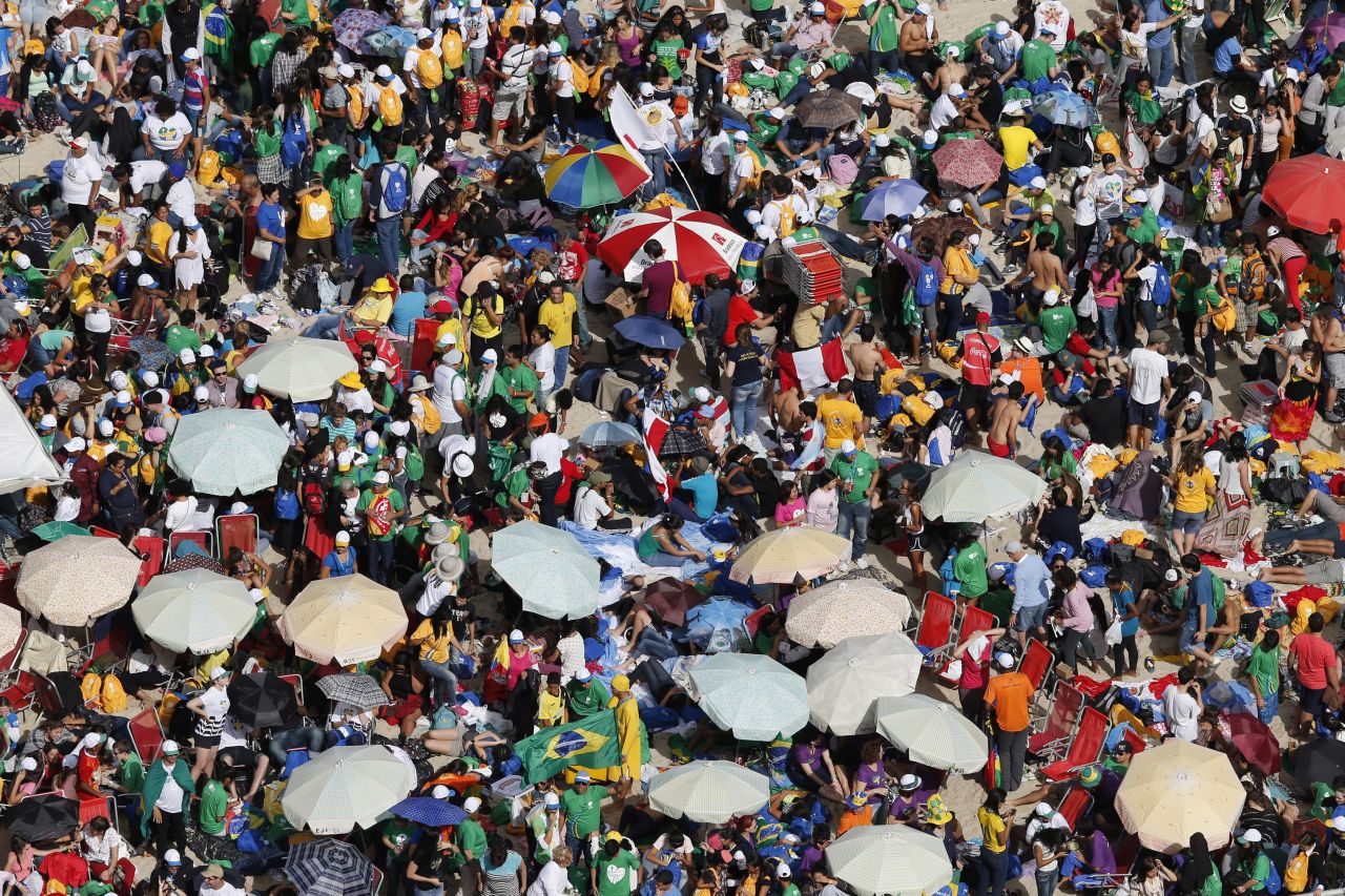 Catholic youths await the arrival of Pope Francis on Copacabana beach in Rio on July 26.