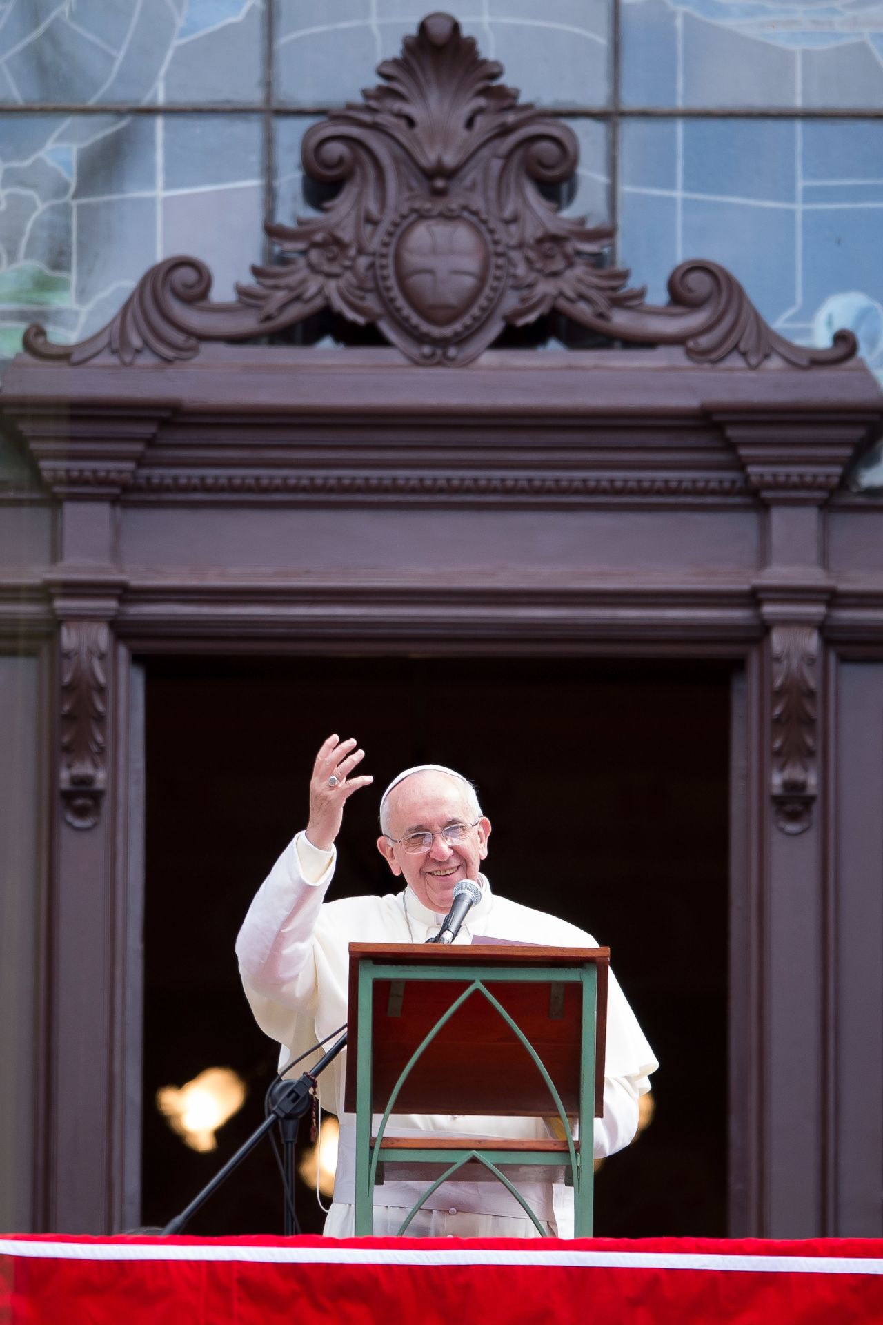Pope Francis speaks to the crowd from a balcony of the San Joaquin Episcopal Palace on July 26 in Rio. More than 1.5 million pilgrims are expected to join the pope for his visit to the Catholic Church's World Youth Day celebrations. 
