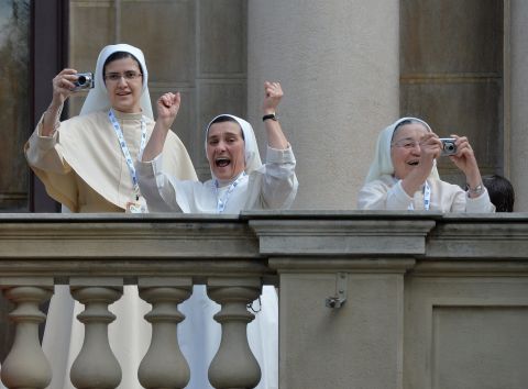 Nuns cheer and take photographs from the central balcony of the Archbishop's Palace in Rio as Pope Francis arrives for the Angelus Prayer on July 26. 