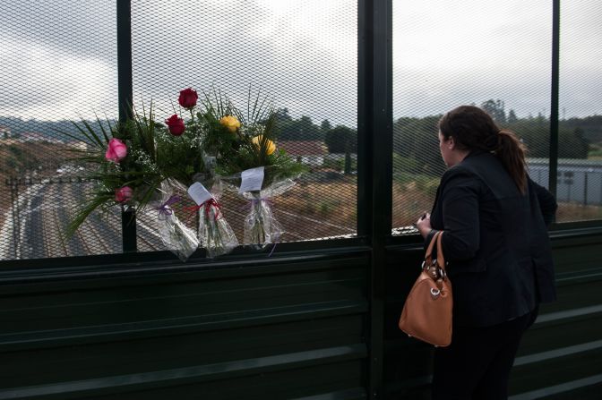 A woman looks over the scene from a bridge on July 26.