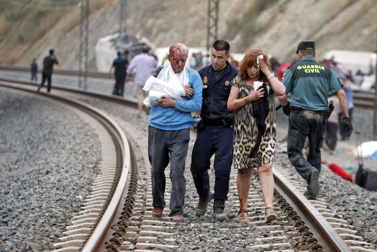 Injured people are evacuated at the site of the July 24 train accident. The driver of the train is being held, Spanish police said July 26.