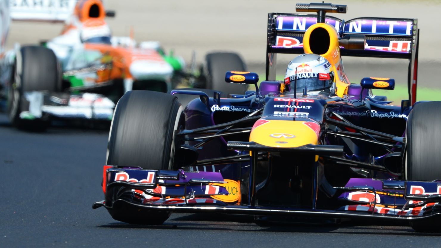 Sebastian Vettel in his Red Bull leads the Force India of Adrian Sutil in practice for the Hungarian Grand Prix. 