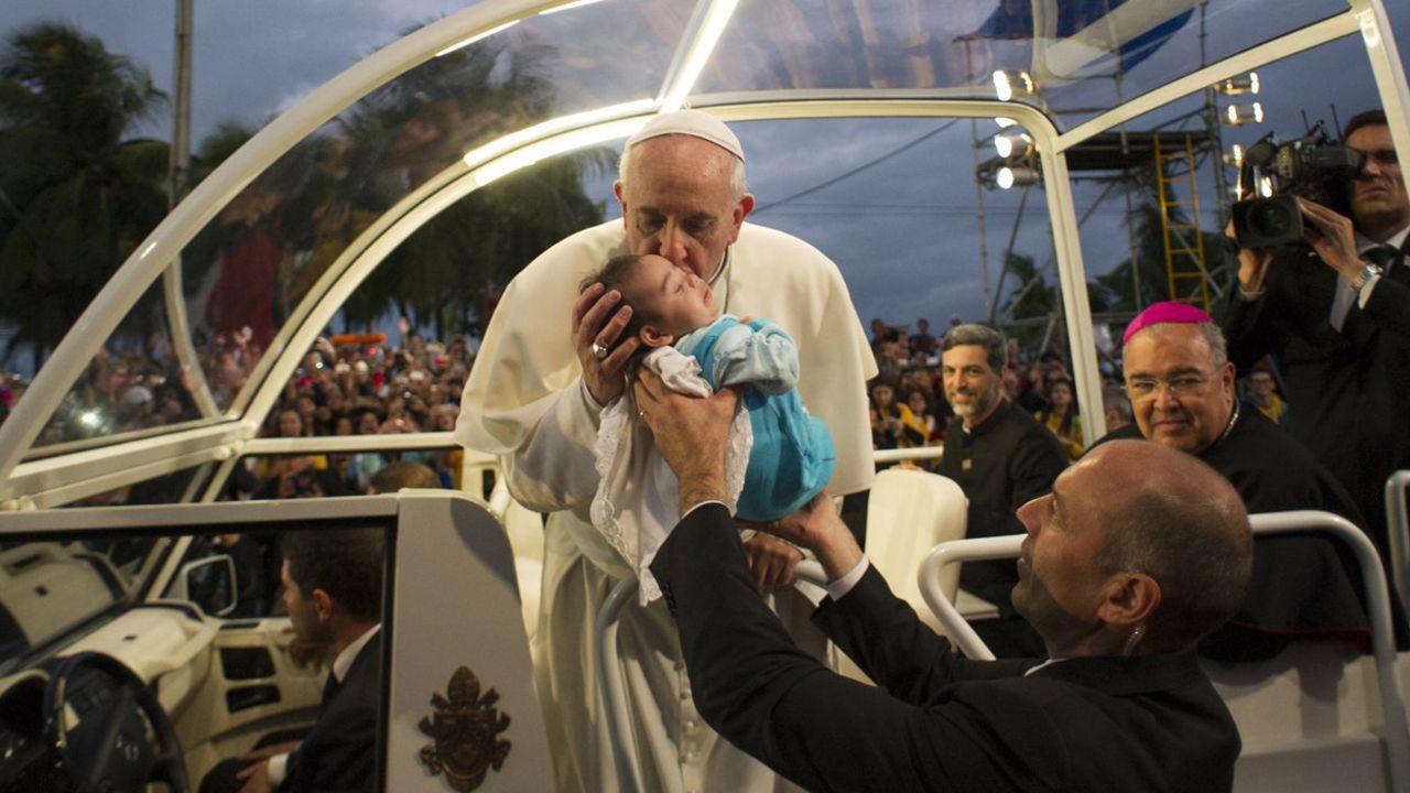 The pope blesses a child as he arrives at Copacabana beach in Rio de Janeiro, on July 26.