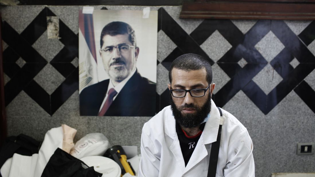 A medic pauses at a field hospital in Cairo on July 27 after tending to the bodies of Morsy supporters reportedly killed in fighting.