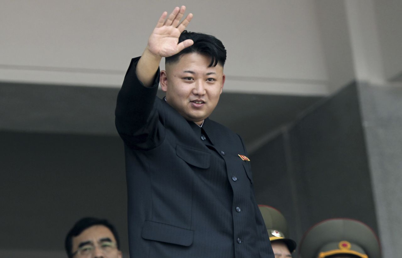 North Korea's leader Kim Jong Un waves to spectators and participants during a military parade on July 27, in Pyongang.