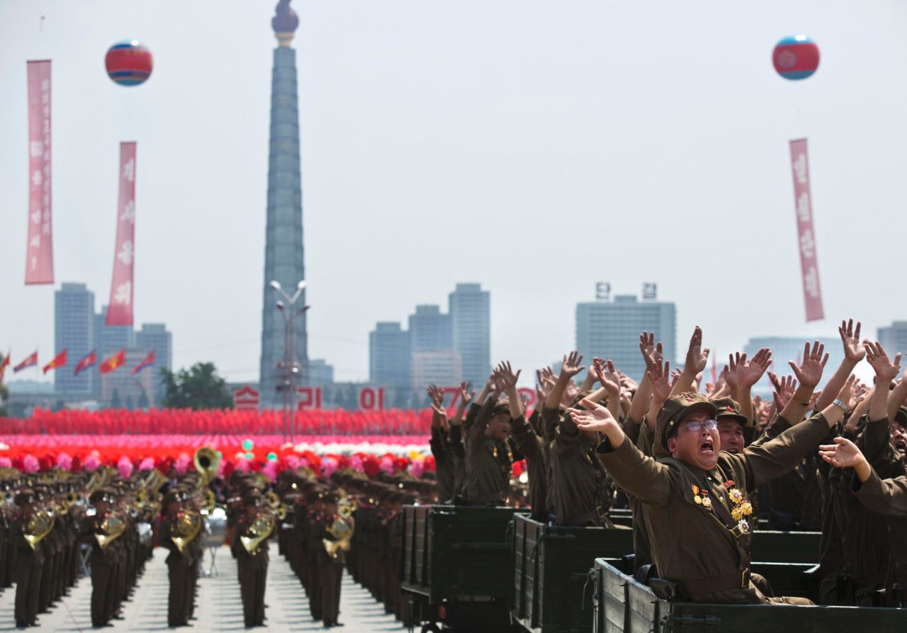 North Korean veterans wave to Kim Jong Un during the parade on July 27. 