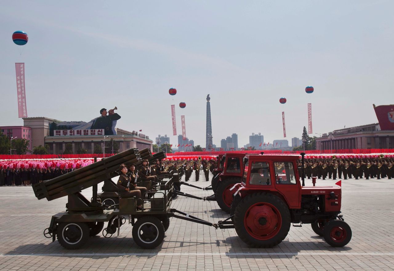 Tractors pull weapon-bearing wagons during the parade on July 27. 