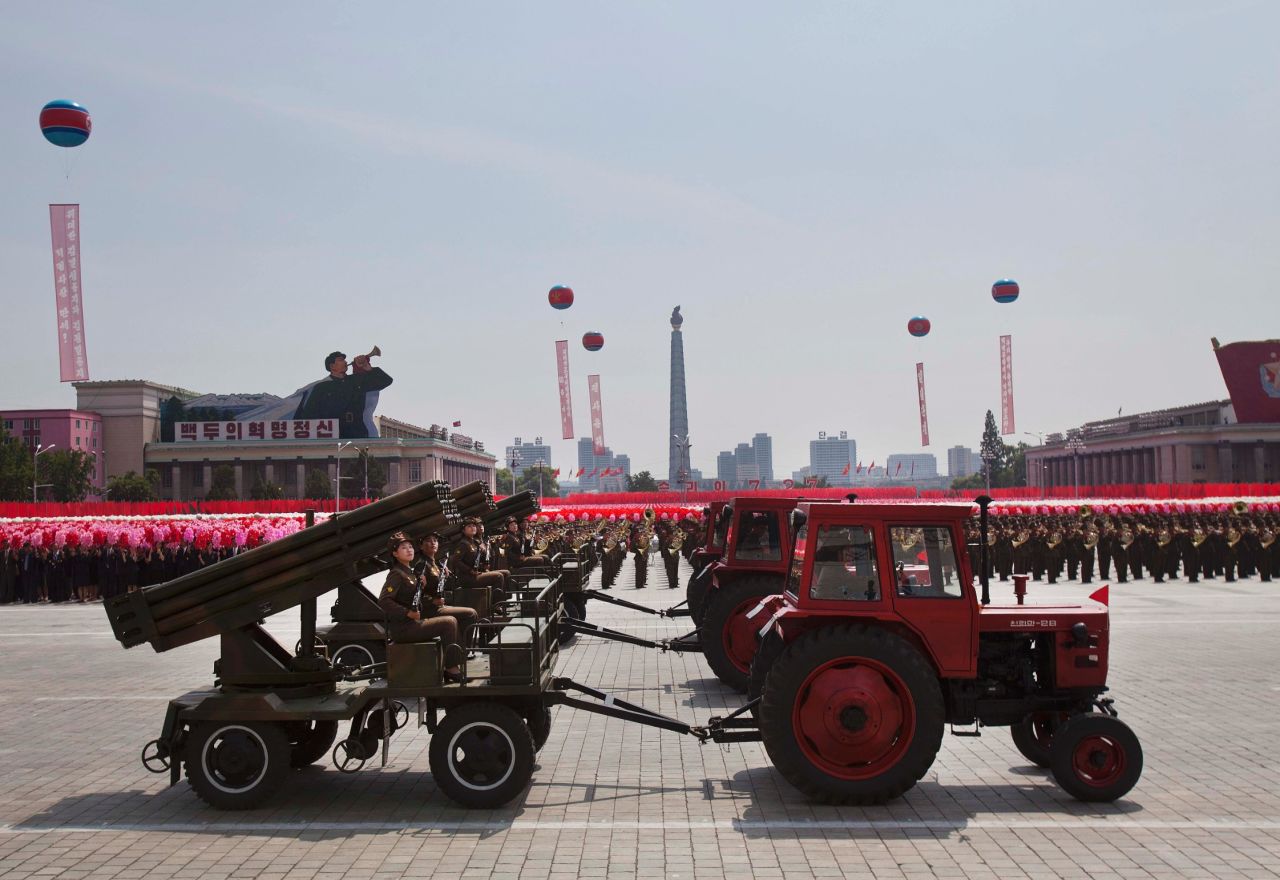 Tractors pull weapon-bearing wagons during the parade on July 27.