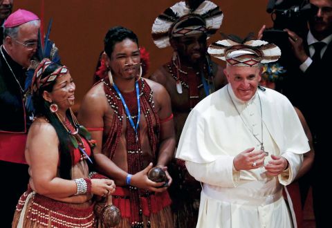 Pope Francis wears an indigenous feathered hat given to him by representatives of one of Brazil's native tribes during a meeting at the Municipal Theater in Rio de Janeiro on July 27. 