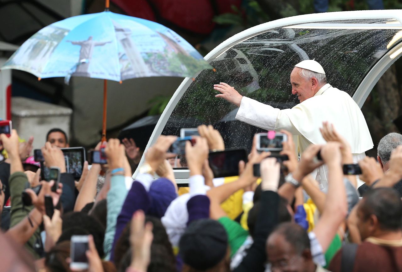 Pope Francis waves to people from the "Popemobile" in Rio de Janeiro on July 27.