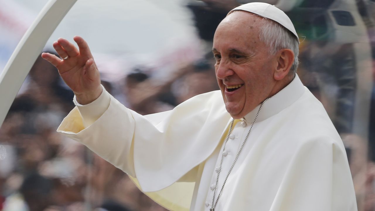 Pope Francis waves to the crowds on his way to Copacabana Beach on July 28.