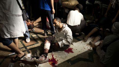 A wounded Morsy supporter lies on the floor of a field hospital in Cairo on July 27. Thousands of Morsy supporters gathered Saturday in the Nasr City neighborhood despite dozens of deaths the night before and veiled threats from the military.