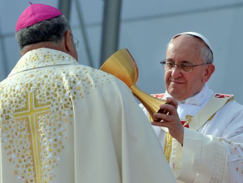 Pope Francis gives a chalice to Rio de Janeiro's Archbishop Orani Joao Tempesta during a Mass on Copacabana Beach on Sunday, July 28. The pontiff has been in the South American country for World Youth Day, a weeklong celebration aimed at revitalizing young Catholics. 