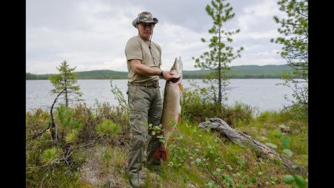 Putin holds a pike he caught in the Siberian Tuva region of Russia on July 20, 2013. 