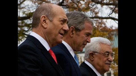 Then-President George W. Bush walks with then-Israeli Prime Minister Ehud Olmert, left, and Palestinian President Abbas on November 27, 2007, during the Annapolis Conference at the U.S. Naval Academy in Maryland. The peace conference was attended by 16 Arab countries, including Saudi Arabia and Syria, Israel and the Palestinians. A joint statement was the only thing agreed upon under heavy American pressure and by avoiding specific reference to any of the core issues. 