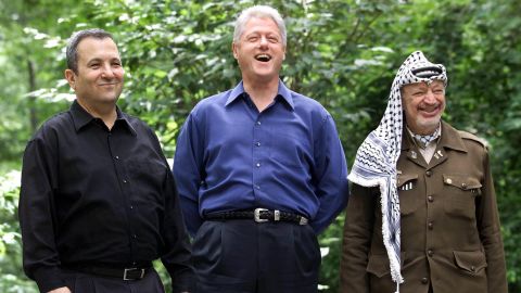 Then-Israeli Prime Minister Ehud Barak, left, with the then-President Bill Clinton and Palestinian leader Yasser Arafat pose for a photograph on July 21, 2000, at Camp David, in Maryland. The Camp David Summit was an effort to resolve the issues of the 52-year-old Israeli-Palestinian conflict including the status of Jerusalem, the borders and nature of a Palestinian state, and the future of Jewish settlers and Palestinian refugees. The Summit ended without an agreement.