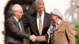 WASHINGTON, DC - SEPTEMBER 13:  US President Bill Clinton (C) stands between PLO leader Yasser Arafat (R) and Israeli Prime Minister Yitzahk Rabin (L) as they shake hands September 13, 1993, at the White House in Washington DC. Rabin and Arafat shook hands for the first time after Israel and the PLO signed a historic agreement on Palestinian autonomy in the occupied territories. (Photo credit J. DAVID AKE/AFP/Getty Images)