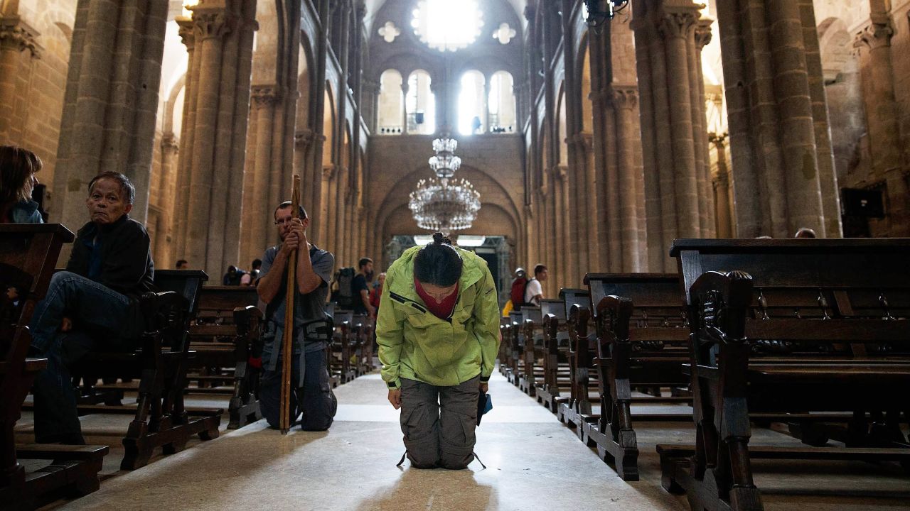 A woman kneels on July 29 in the cathedral.