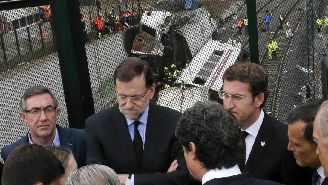 Spanish Prime Minister Mariano Rajoy, second from left, and Galicia's regional President Alberto Nunez Feijoo, right, visit the site of the derailment on Friday, July 26.