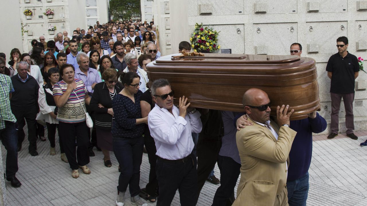 People carry the coffin of a victim at the San Pedro de Visma cemetery in A Coruna, Spain, on July 27.