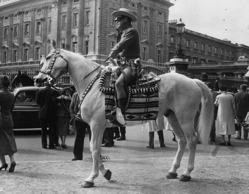 The Lone Ranger character spawned novels, comic books, a TV series and films around the world. Here Moore visits London's Buckingham Palace in costume as part of an appearance on BBC radio and TV in 1958.