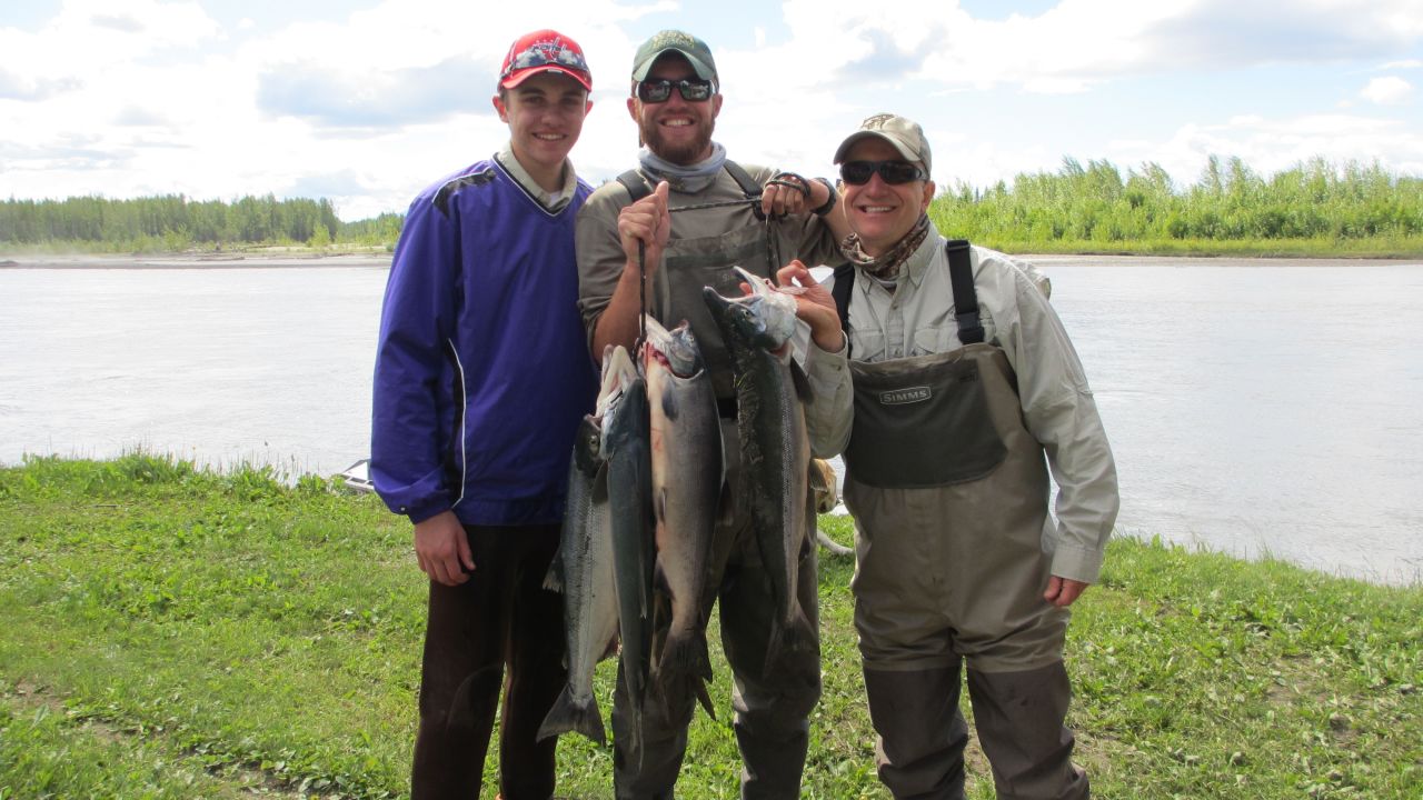The author, far right, proudly displays a morning's catch on Alaska's Yentna River with his sons Charlie, left, and John. 
