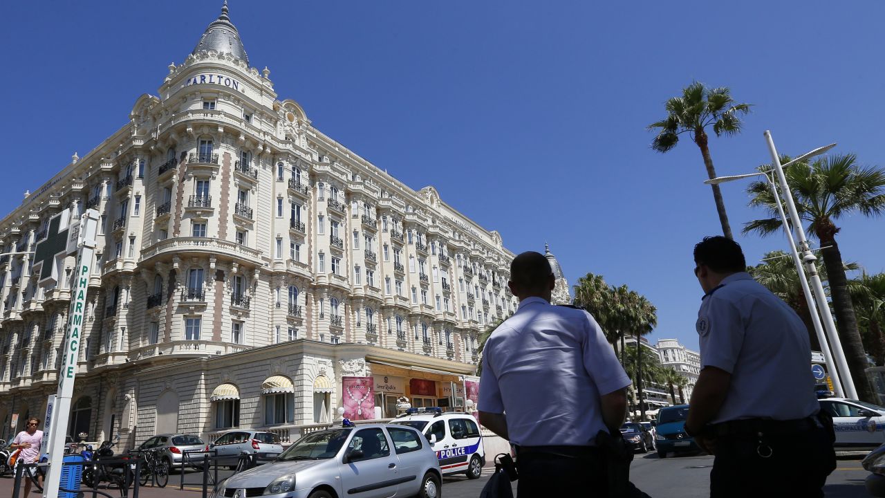 French policemen keep watch outside the Carlton Hotel on July 28, 2013 in the French Riviera resort of Cannes, after an armed man held up the jewellery exhibition 'Extraordinary diamonds' of the Leviev diamond house, making away with jewels estimated to be worth about 40 million euros ($53 million), according to investigators. The lone gunman managed to evade security and escape with a briefcase containing the valuable jewellery. AFP PHOTO / VALERY HACHE (Photo credit should read VALERY HACHE/AFP/Getty Images)