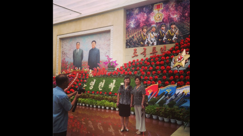 "This was most tightly controlled restricted foreign assignment of my career," Watson said of his visit to the country. Here <a href="http://instagram.com/p/cNgHU6CDbv/" target="_blank" target="_blank">visitors take souvenir photos</a> at the Kimilsungia and Kimjongilia flower festival. The flowers are named after former North Korean leaders Kim Il Sung and Kim Jong Il, who overlook the scene from the painting on the left hand side.