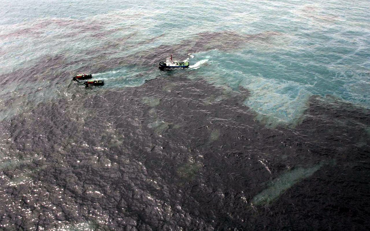 Boats work to clean up the spill southeast of Bangkok on Saturday, July 27.