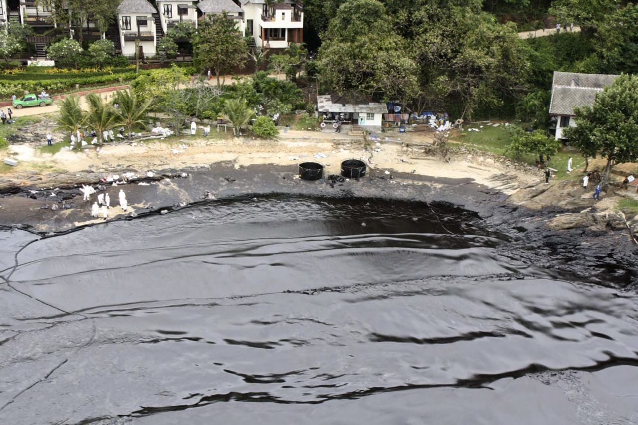 Blacked water laps onto the beach in front of a resort on the island of Koh Samet on Monday, July 29. Tourists have been evacuated from the popular Thai weekend destination.