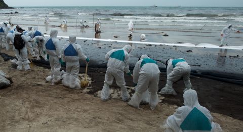 Thai navy personnel work at the scene of the oil spill at Ao Phrao on July 30.