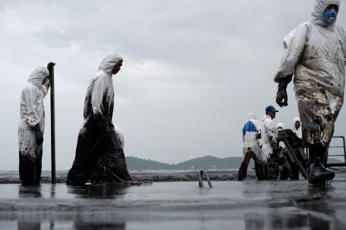 JULY 30 - KO SAMET, THAILAND: Royal Thai Navy personnel clean a beach after a <a href="http://cnn.com/2013/07/30/travel/koh-samet-oil-spill/index.html?hpt=hp_t3">major oil slick coated a beach</a> in a national park on the popular tourist island. Authorities estimate around 5,000 liters of crude oil have washed up on the island after leaking into the ocean from an offshore pipeline. Tourists staying in the area were evacuated as the bay turned black.