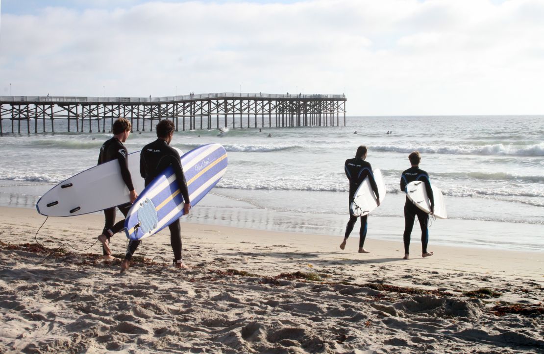 Swimmers and surfers flock to Pacific Beach.