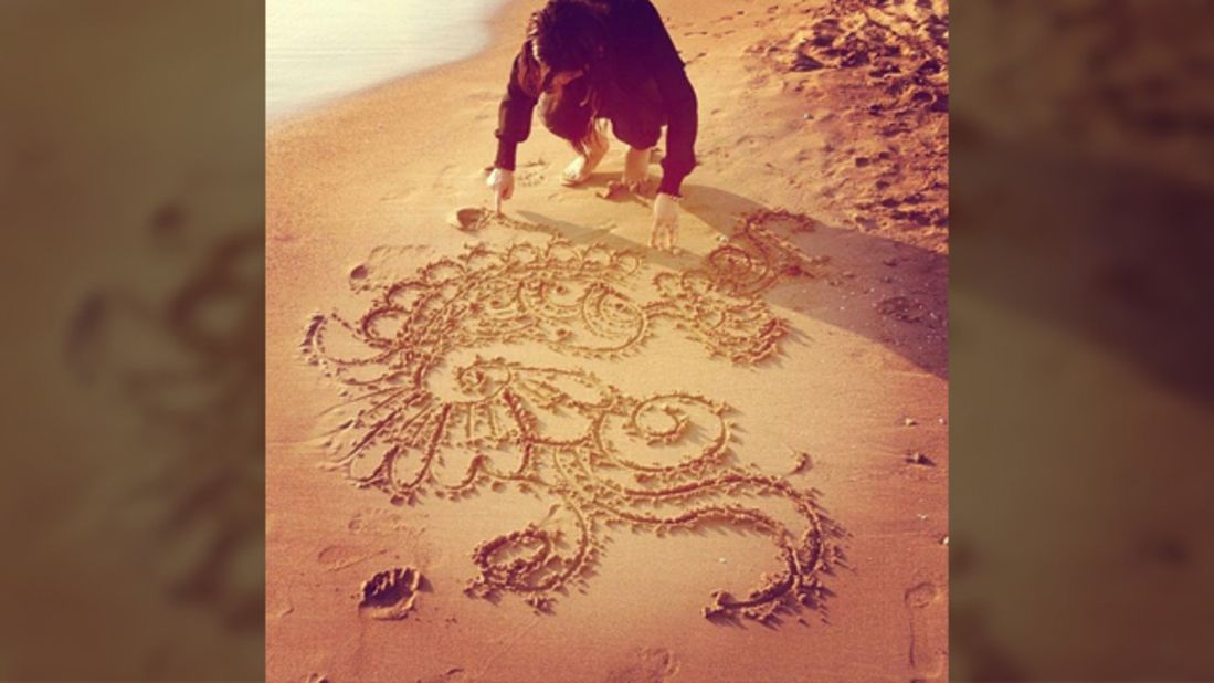 In this photo Farrah Azam can be seen drawing one of her henna designs in the sand at a beach in Antalya, Turkey. The 26-year-old <a href="http://statigr.am/viewer.php#/user/254704119/" target="_blank" target="_blank">henna artist from London</a> creates bespoke designs but unusually she paints it on canvases and other objects rather than on body parts. <br /><br />"I am a practicing Muslim who participates in the month of fasting. Eid marks the end of the month of fasting and I celebrate it with my family and friends by visiting the mosque for the special Eid prayer, having a lavish meal, exchanging gifts and meeting relatives," she said.