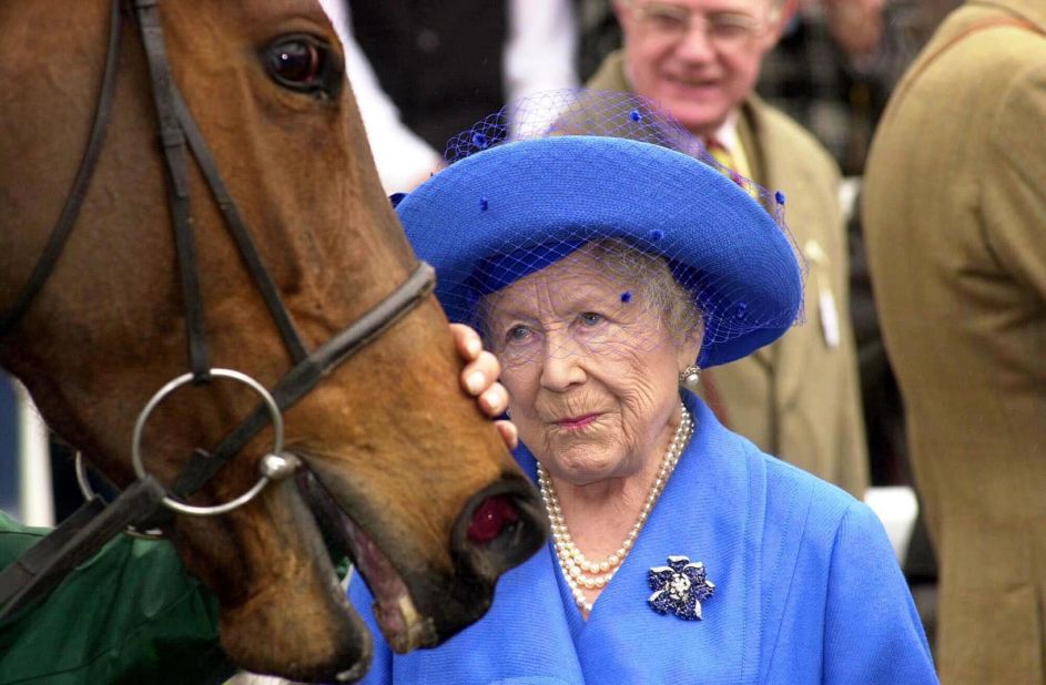 The late Queen Mother pats one of her winning horses Bella Macrae after a race at Sandown Park in 2001. She was 100 years of age and still actively involved in the sport before her passing the following year.  