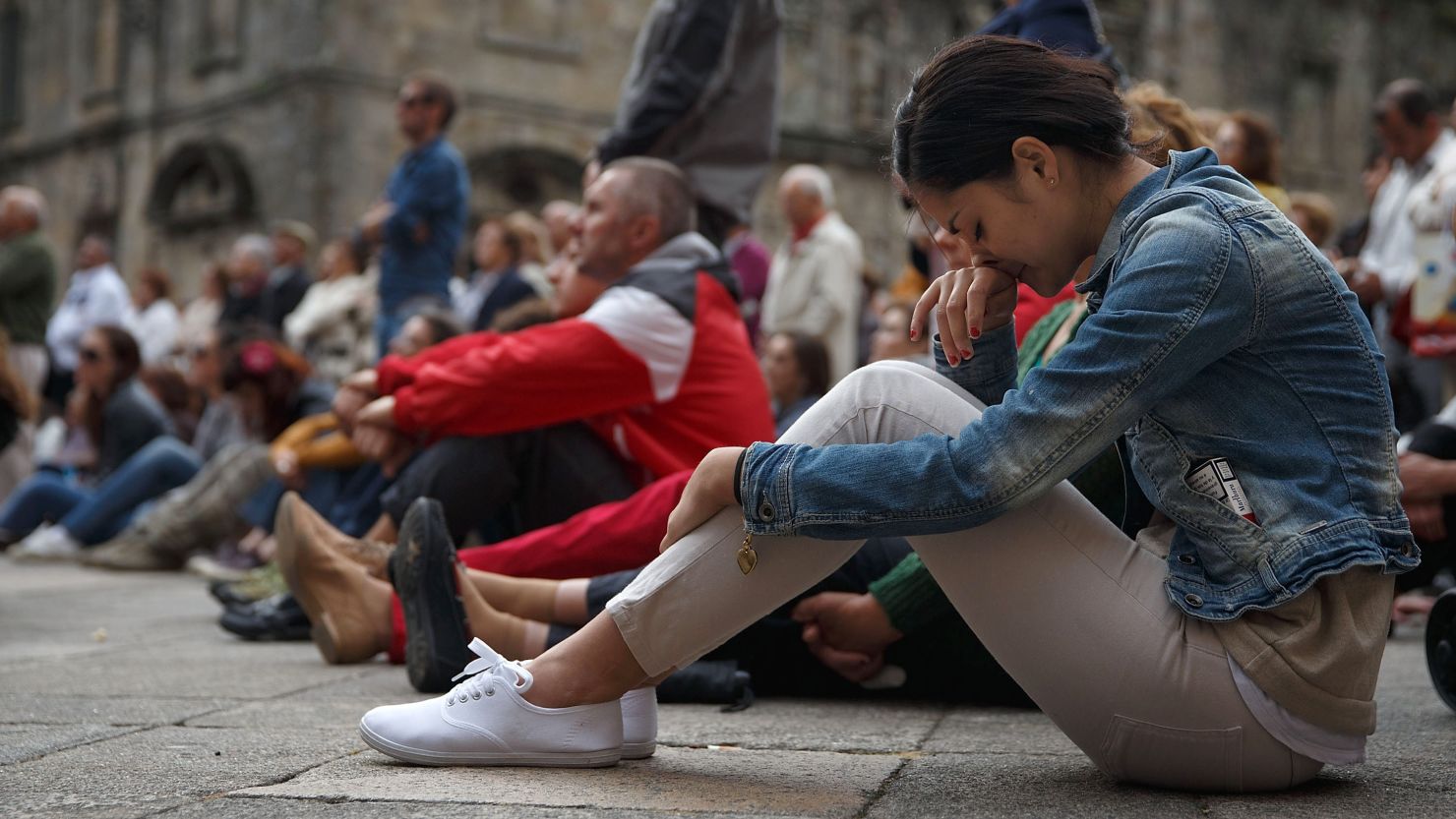  A woman watches the memorial service for the victims of the crash, at Santiago de Compostela Cathedral on July 29, 2013.