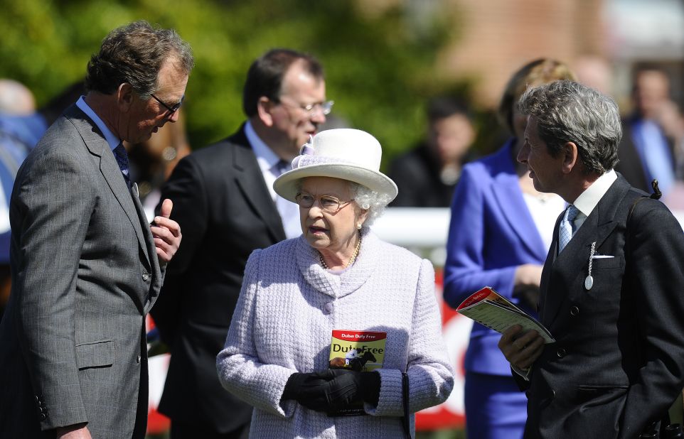 Queen Elizabeth II with her racing manager John Warren (left) and trainer Roger Charlton at Newbury racecourse in April 2013. Her horse Sign Manual was among the winners at the meeting.