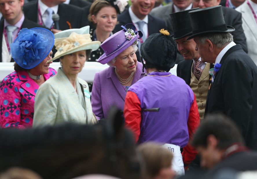 Britain's monarch shares a private moment with her connections and jockey Ryan Moore after the historic victory in June 2013. Her only daughter Princess Anne, who represented Britain at the 1976 Olympics in equestrian, is to her left. 