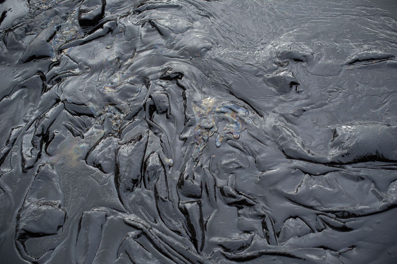 Normally pristine white sand is covered in black muck, pictured on Wednesday, July 30.