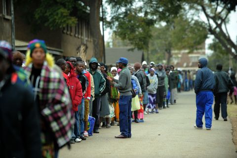 Zimbabweans line up near a polling station in Harare to <a href="http://cnn.com/2013/07/31/world/africa/zimbabwe-election/index.html?hpt=hp_t1">vote in a general election</a> on July 31, 2013 as President Robert Mugabe seeks to extend power to a potential 38 years.
