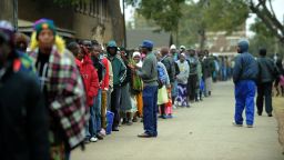 Zimbabweans line up near a polling station in Harare to vote in a general election on July 31, 2013 as President Robert Mugabe seeks to extend power to a potential 38 years.