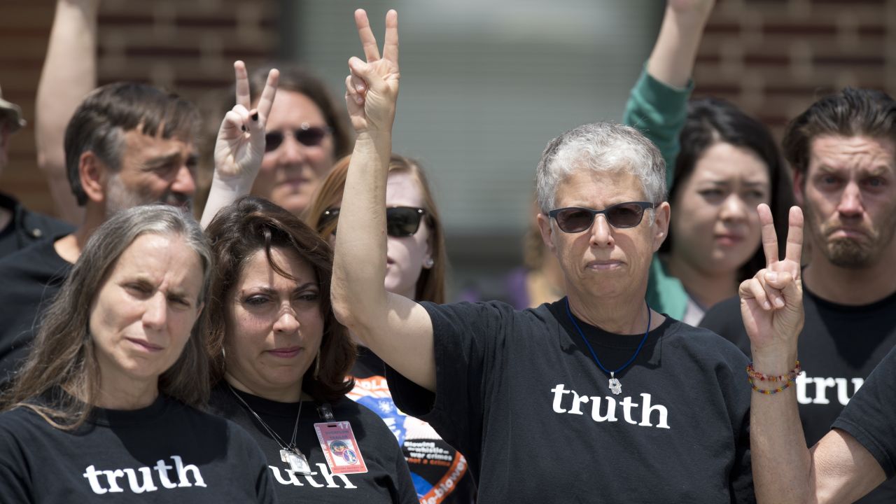Bradley Manning supporters make peace signs after the Manning verdict was announced July 30.