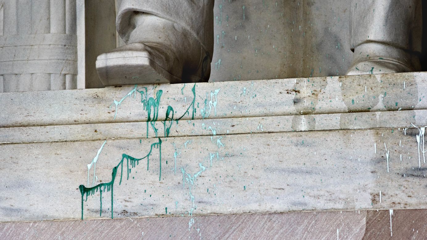 Green paint is splattered on the base of the statue on July 26.